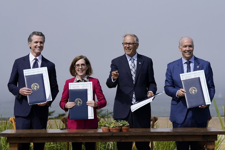 From left, California Gov. Gavin Newsom, Oregon Gov. Kate Brown, Washington Gov. Jay Inslee and British Columbia Premier John Horgan after signing a new climate agreement at the Presidio Tunnel Tops in San Francisco on Thursday. (Jeff Chiu / The Associated Press)