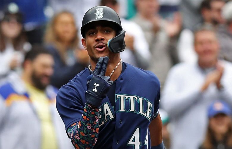 Mariners center fielder Julio Rodriguez arrives at home plate after homering against the Tigers in the first inning during the last game of the regular season, Wednesday, Oct. 5, 2022 in Seattle.