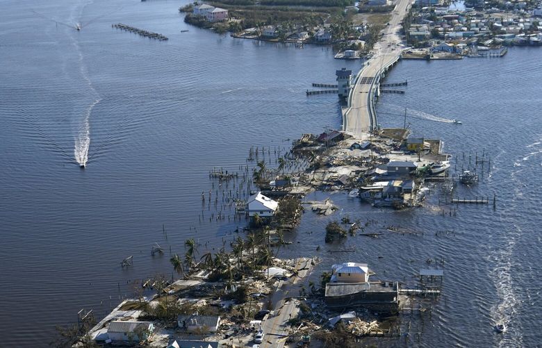 The bridge leading from Fort Myers to Pine Island, Fla., is seen heavily damaged in the aftermath of Hurricane Ian on Pine Island, Fla., Saturday, Oct. 1, 2022. Due to the damage, the island can only be reached by boat or air. (AP Photo/Gerald Herbert) FLGH134 FLGH134