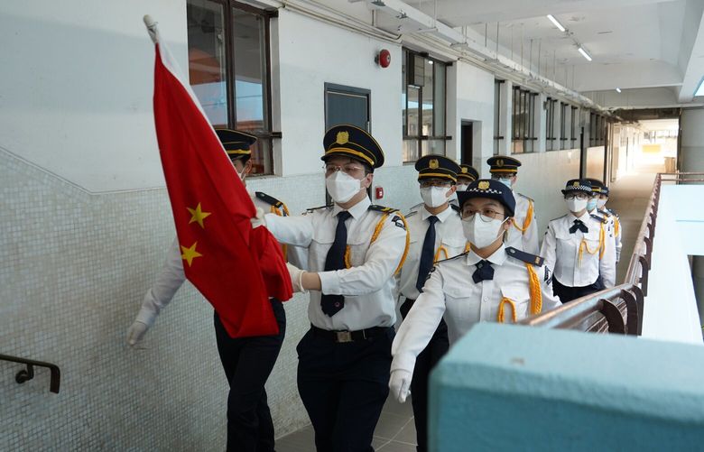 Students march during a flag-raising ceremony at Hong Kong’s Scientia Secondary School on Sept. 16, 2022. MUST CREDIT: Washington Post photo by Theodora Yu.