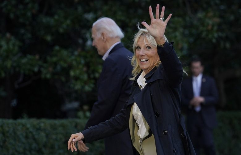 First lady Jill Biden waves as she and President Joe Biden walk across the South Lawn of the White House in Washington, Wednesday, Oct. 5, 2022, after returning from a trip to Florida to survey damage from Hurricane and Ian. (AP Photo/Susan Walsh) DCSW101 DCSW101