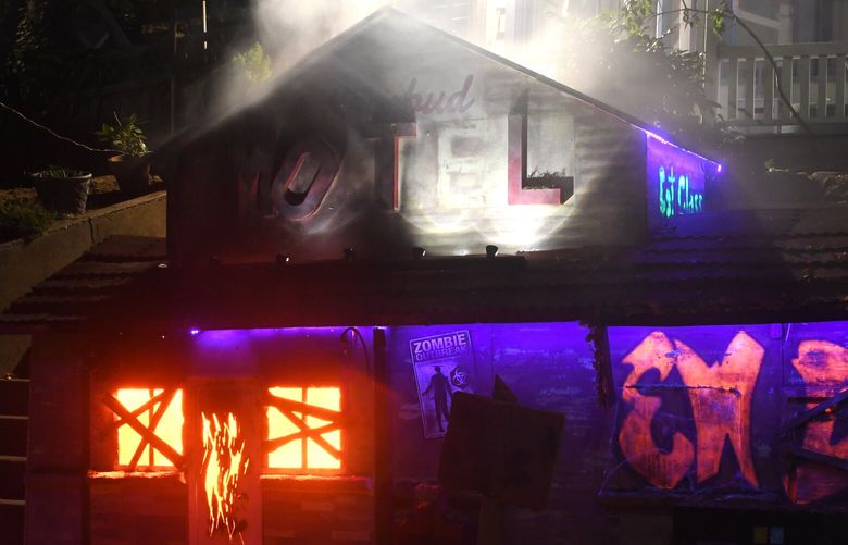 Queen Anne resident Richard Knowles III built a mini Rosebud Motel in front of his home. The fire and smoke effects are especially impressive lit up at night. (JiaYing Grygiel / Special to The Seattle Times)