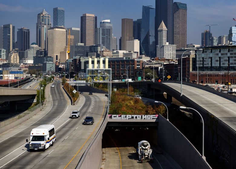 Downtown Seattle looms behind the south portal of the Highway 99 tunnel, which isn&#8217;t generating enough toll income to pay for maintenance and $200 million in construction debt. (Ken Lambert / The Seattle Times)
