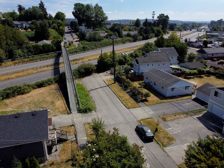 South Henderson Street in the South Park neighborhood of Seattle is sliced through by a stretch of Highway 99 that activists want decommissioned to improve their community, seen from the air on Aug. 21, 2022. (Ken Lambert / The Seattle Times)