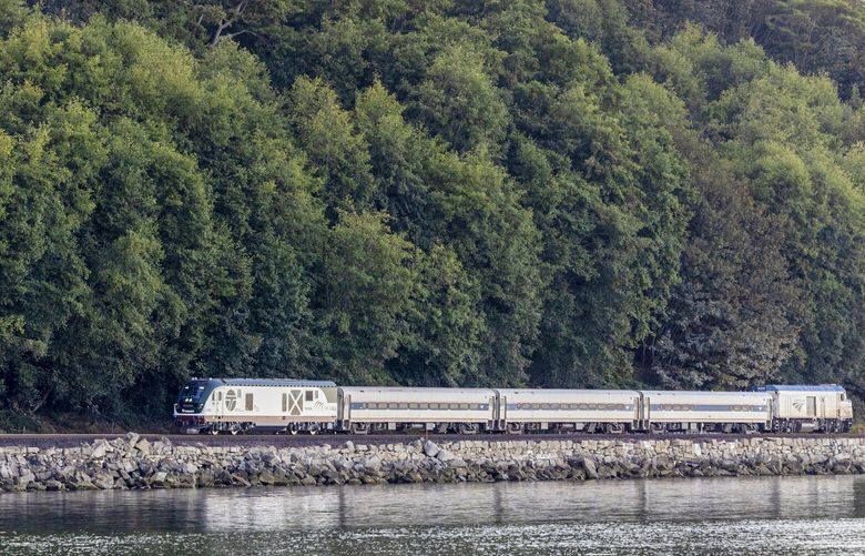 The Amtrak Cascades train running from Seattle to Vancouver, B.C., passes by Carkeek Park in Seattle Oct. 11, 2022.