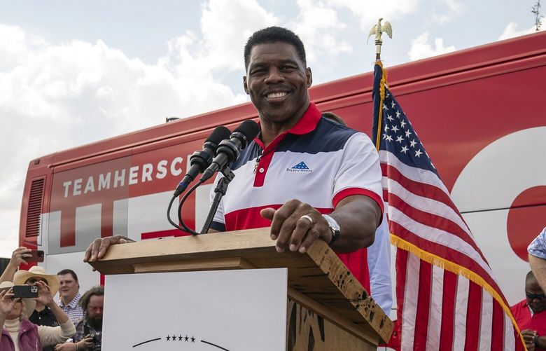 Herschel Walker, the Republican candidate for Senate, is joined onstage by Sen. Rick Scott (R-Fla.) as he speaks during a campaign rally in Carrollton, Ga., Oct. 13, 2022. The Senate candidate in Georgia has been slammed by allegations, but he should not have been surprised — Republicans have been discussing the arrival of this moment for months. (Nicole Craine/The New York Times) XNYT86 XNYT86