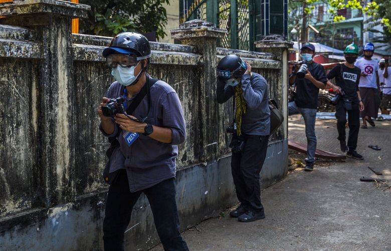 — EMBARGO: NO ELECTRONIC DISTRIBUTION, WEB POSTING OR STREET SALES BEFORE 3 A.M. ET ON WED. OCT. 12, 2022. NO EXCEPTIONS FOR ANY REASONS — FILE — Journalists covering a protest near Yangon, Myanmar on Feb. 18, 2021. Myanmar is now one of the world’s most dangerous places for journalists after the army seized power in a coup last year. (The New York Times) XNYT160 XNYT160
