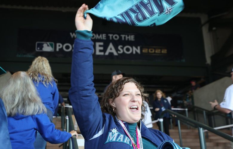 Cori Eischen, who works for the Seattle Mariners, welcomes fane to T-Mobile Parl at the start of the American League Division Series Game 3 of the Seattle Mariners play the Houston Astros on Thursday, Oct. 15, 2022 in Seattle. 221879 221879