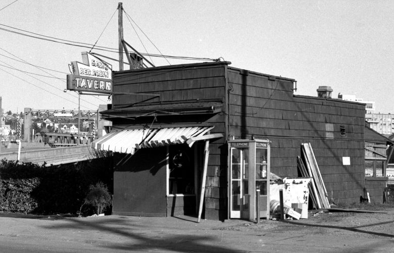 THEN: This north-facing view from 1969 by Paul Gillingham, today a retired trial lawyer and Ravenna resident, shows Sam’s Red Robin Tavern at 3272 Fuhrman Ave. E., near the south end of the University Bridge. Heidelberg and Budweiser boxes and a beer keg lie next to a now-rare telephone booth. Seattle Times restaurant columnist John Hinterberger cracked, “In the old Robin, if they’d passed a pool cue around, someone would have smoked it.”
