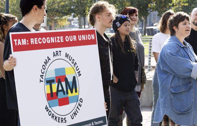 Eden Redmond, Tacoma Art Museum institutional giving manager, (at podium) joins employees of the Tacoma Art Museum and others
at Tollefson Plaza, across Pacific Avenue from the museum in downtown Tacoma Monday, October 17, 2022, to announce their unionization efforts.  She introduced other employees, as well as local and state labor leaders, who spoke on behalf of their efforts.
 221854