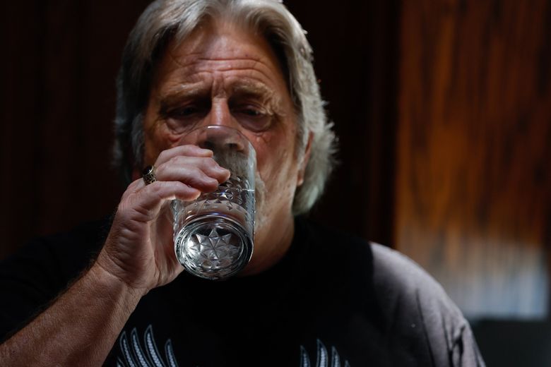 Lance Ostrom can drink water from the tap in his kitchen since making the decision to put in a more-than $7,000 filtration system, which has reduced the PFAS to undetectable levels. (Jennifer Buchanan / The Seattle Times)