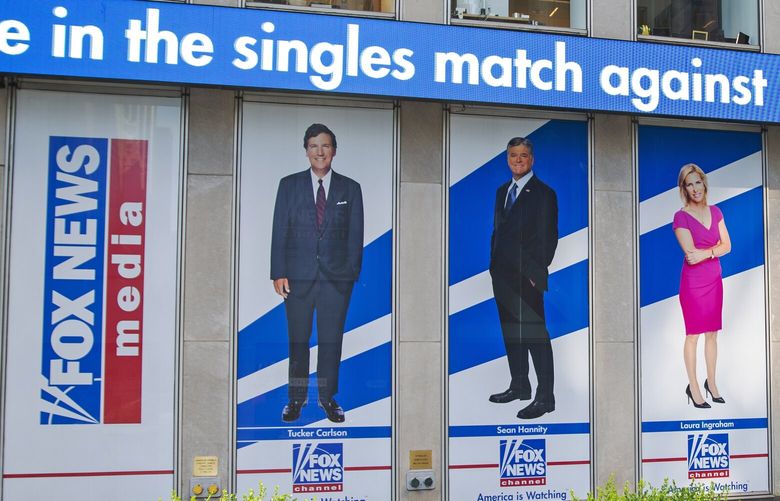 Pictured in promotional posters outside Fox News studios at News Corporation headquarters in New York on Saturday, July 31, 2021, are hosts Tucker Carlson, Sean Hannity, Laura Ingraham, Maria Bartiromo, Stuart Varney, Neil Cavuto and Charles Payne. (AP Photo/Ted Shaffrey)