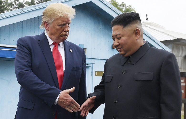 FILE – North Korean leader Kim Jong Un, right, and U.S. President Donald Trump prepare to shake hands at the border village of Panmunjom in the Demilitarized Zone, South Korea on June 30, 2019. (AP Photo/Susan Walsh, File) TOK609 TOK609