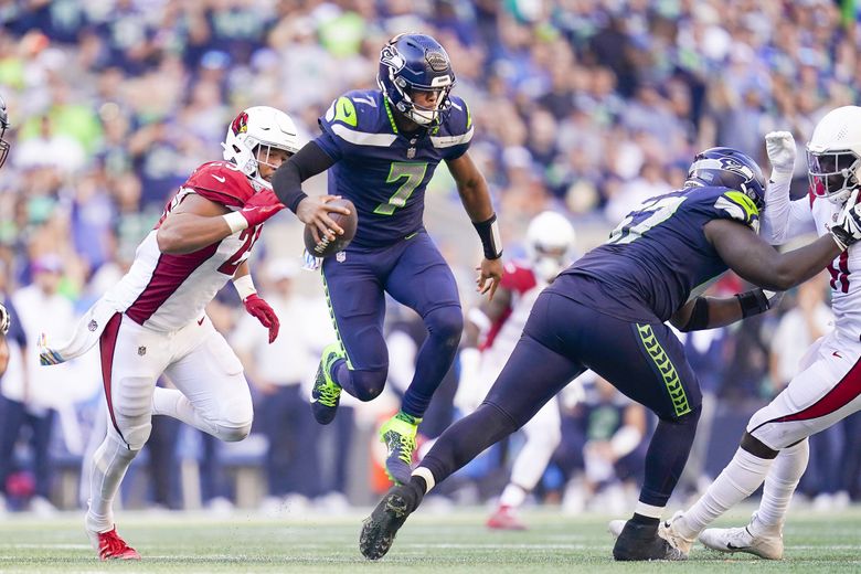 Seattle Seahawks quarterback Geno Smith (7) walks off the filed after an  NFL football game against the Carolina Panthers, Sunday, Dec. 11, 2022, in  Seattle, WA. The Panthers defeated the Seahawks 30-24. (