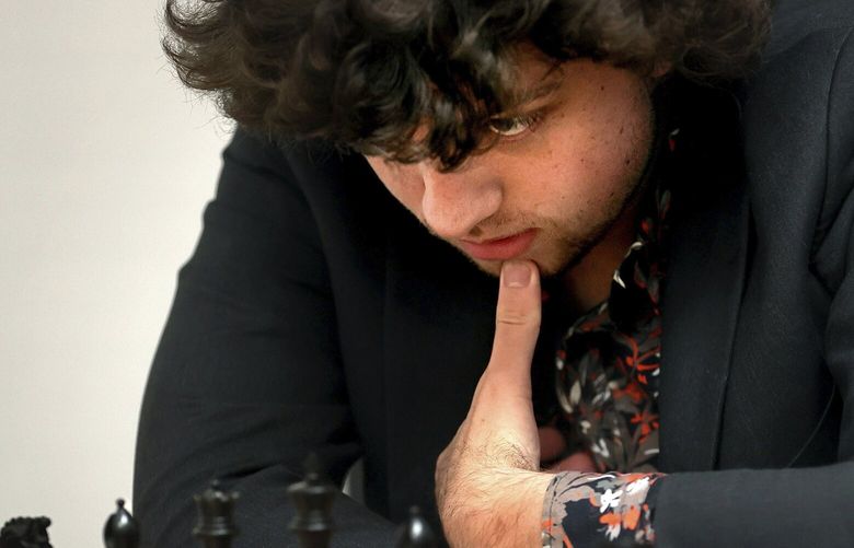 FILE – Chess Grandmaster Hans Niemann, 19, studies the board during a match against Grandmaster Christopher Yoo, 15, at the U.S. Chess Championship in St. Louis on Wednesday, Oct. 5, 2022. Niemann alleges in a federal lawsuit that chess world champion Magnus Carlsen and others destroyed his career by falsely accusing him of cheating.  He is seeking $100 million in damages in the lawsuit filed Thursday, Oct. 20, 2022, in U.S. District Court in St. Louis.  (David Carson/St. Louis Post-Dispatch via AP) MOSTP301 MOSTP301