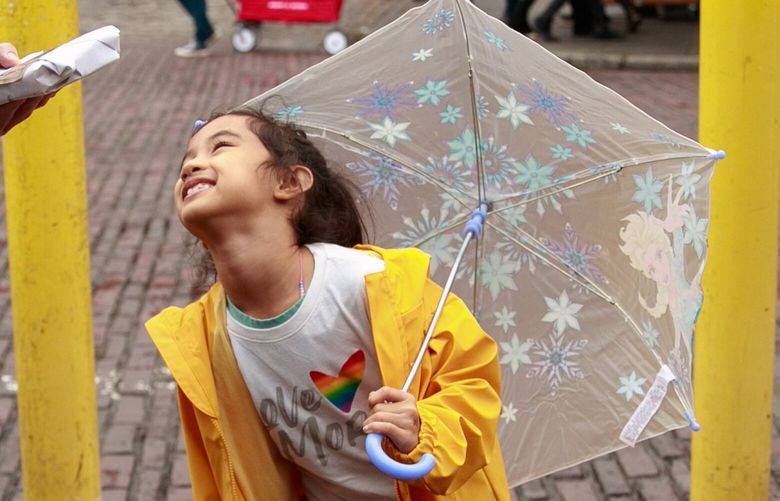 Francis Tubo, left, photographs his daughter Charlie, 6 1/2, at Pike Place Market in Seattle Friday, Oct. 21, 2022. Rain showers sprinkled the Seattle-area after days of unhealthy air quality. Tubo says he has been waiting for the rain and loves the fresh air.
LO 221954
