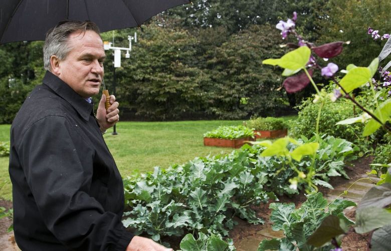 FILE – Dale Haney, Superintendent of the White House Grounds, talks in the first lady Michelle Obama’s vegetable and herb garden on the South Lawn of the White House in Washington, Oct. 15, 2009. Haney has been a constant through the past 10 presidencies. As of this month, Haney has tended the lawns and gardens of the White House for 50 years. (AP Photo/Alex Brandon, File) WX451 WX451