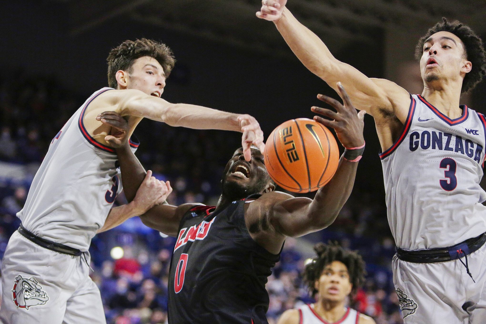 Gonzaga center Chet Holmgren, left, defends Santa Clara guard