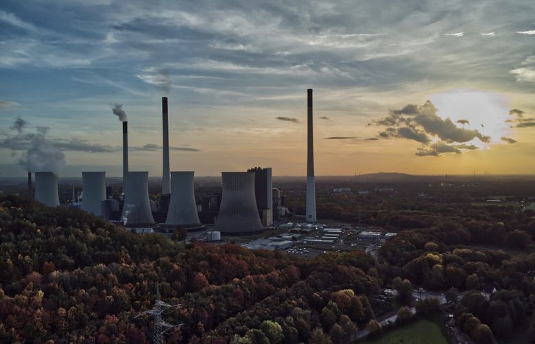 FILE – The sun sets behind a coal-fired power plant in Gelsenkirchen, Germany, Oct. 22, 2022. A new report from doctors and other health experts says the world’s fossil fuel addiction is making the world sicker and is killing people. (AP Photo/Michael Sohn, File) CLI301 CLI301