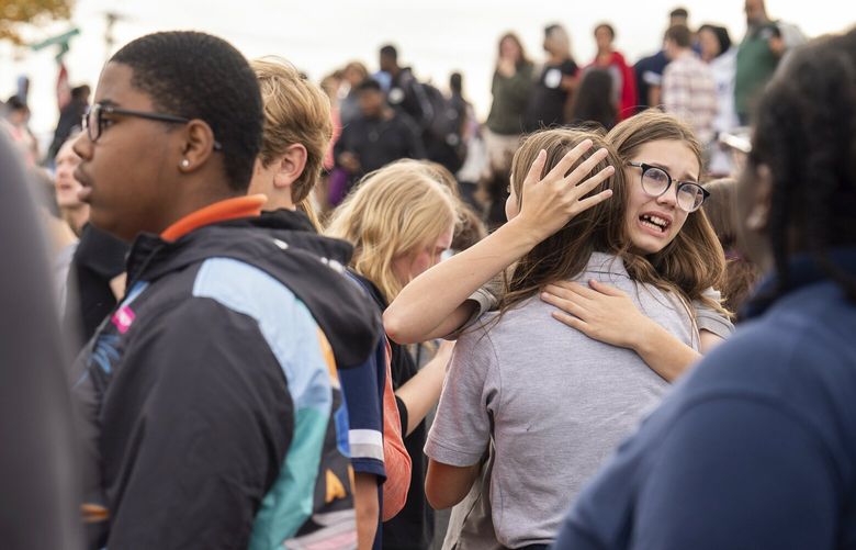 People gather outside after a shooting at Central Visual and Performing Arts high school in St. Louis, on Monday, Oct. 24, 2022. (Jordan Opp/St. Louis Post-Dispatch via AP) MOSTP301 MOSTP301