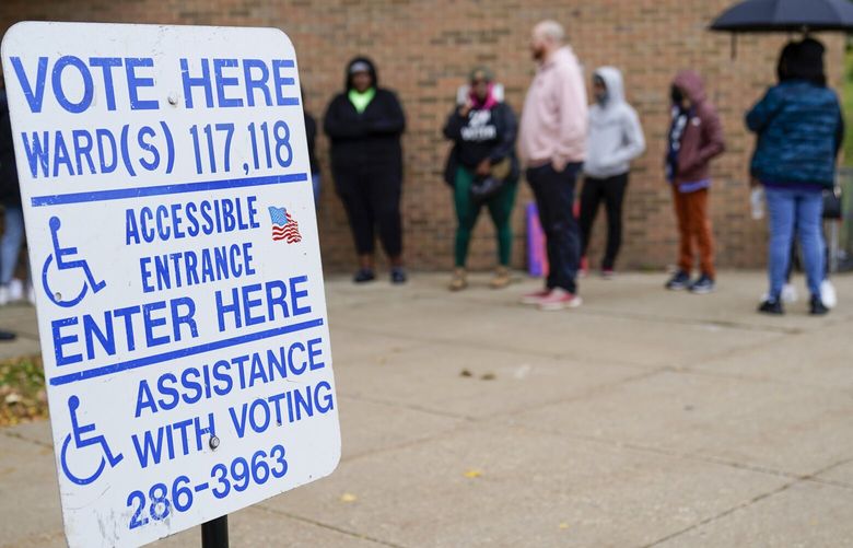 People line up outside a polling station to cast their votes Tuesday, Oct. 25, 2022, in Milwaukee. Tuesday is the first day to vote early in Wisconsin. (AP Photo/Morry Gash) WIMG109 WIMG109