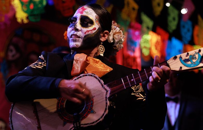 Vihuelista and vocalist Dulce G—mez, with Mariachi Femenil Estrellas de Mexico, from Guadalajara, Jalisco, performs at the week-long Catrinas Festival, celebrating D’a de los Muertos, at Club Sur in Seattle on Wednesday. 221984