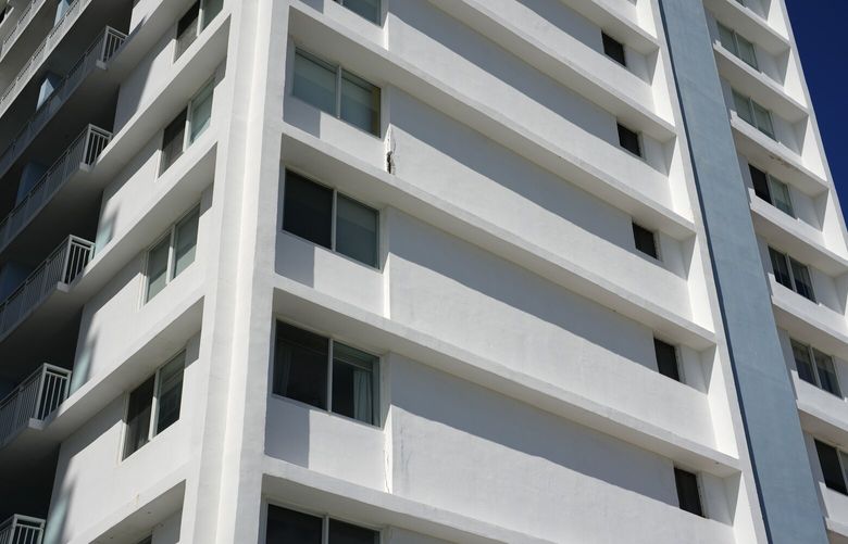 A few small cracks are seen in exterior concrete on the beachfront facade of the Port Royale building at 6969 Collins Ave., after it was ordered evacuated Thursday due to concerns over its structural safety, in Miami Beach, Fla., Friday, Oct. 28, 2022. An evacuation order has abruptly forced out residents of the 14-story oceanfront building on the same avenue where a condominium collapse killed nearly 100 people last year. (AP Photo/Rebecca Blackwell) FLRB104 FLRB104