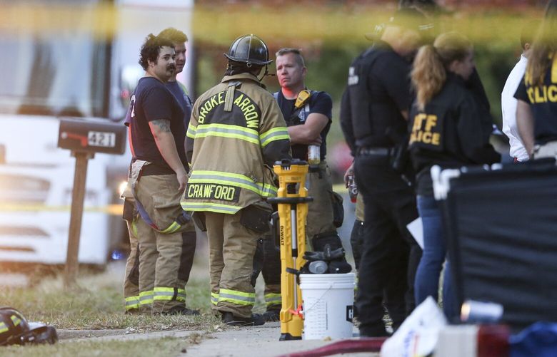 Broken Arrow, Okla., police and fire department investigate the scene of a fire with multiple fatalities at the corner South Hickory Ave. and West Galveston St. on Thursday, Oct. 27, 2022. Eight people were found dead Thursday after a fire was extinguished at a Tulsa-area house, and police said they were investigating the deaths as homicides. (Ian Maule/Tulsa World via AP) OKTUL903 OKTUL903