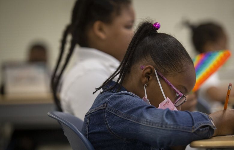 FILE – Students work in a classroom at Beecher Hills Elementary School in Atlanta on Friday, Aug. 19, 2022. The COVID-19 pandemic that shuttered classrooms set back learning in some U.S. school systems by more than a year, with children in high-poverty areas affected the most, according to a district-by-district analysis of test scores shared exclusively with The Associated Press. (AP Photo/Ron Harris, File) NYSS413 NYSS413
