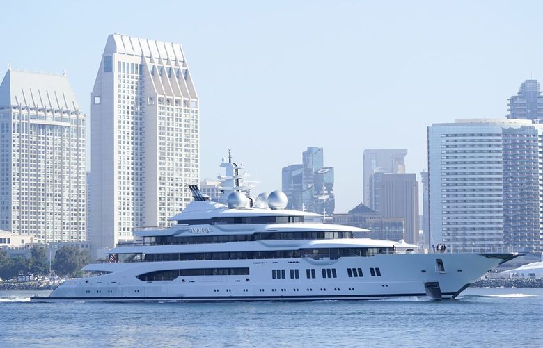 The super yacht Amadea passes San Diego as it comes into the San Diego Bay Monday, June 27, 2022, seen from Coronado, Calif. The $325 million superyacht seized by the United States from a sanctioned Russian oligarch arrived in San Diego Bay on Monday. (AP Photo/Gregory Bull)