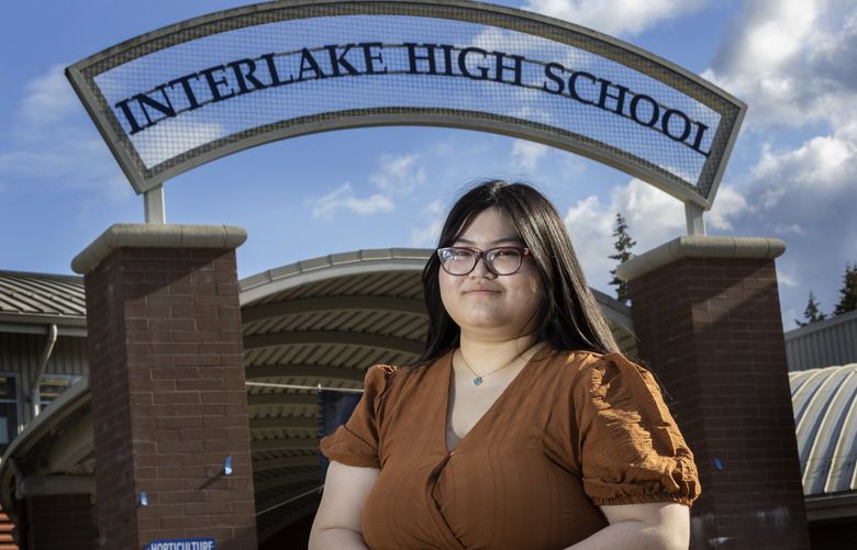 Diane Sun, a 17-year-old Interlake High School senior, will represent Washington state on the USA Debate Team and as the National Student Poet of the West.  She is at the entrance to her high school Friday, September 30, 2022. 221708