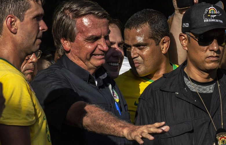 Brazil’s far-right president, Jair Bolsonaro, with supporters at a campaign rally on the outskirts of Rio de Janeiro, Oct. 27, 2022. Brazilians head to the polls on Sunday, Oct. 30, 2022, in a presidential election between two political heavyweights, Bolsonaro and the leftist Luiz Inacio Lula da Silva, that could have global repercussions. (Dado Galdieri/The New York Times) XNYT110 XNYT110