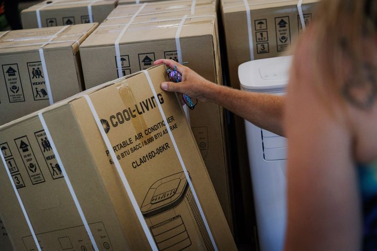 Customers examine an air conditioning unit