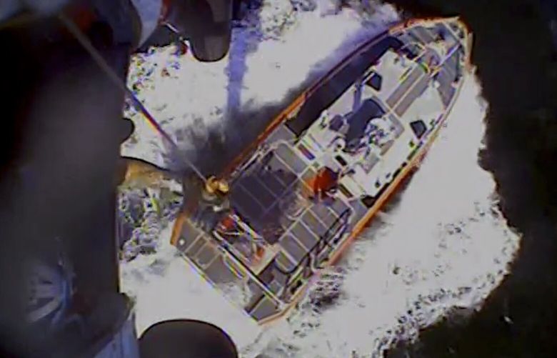 In this screenshot from video, the U.S. Coast Guard rescues boaters off the coast of Empire, La., on Sunday, Oct. 9, 2022. Three men whose fishing boat sank in the Gulf of Mexico off the Louisiana coast were rescued after surviving for more than a day despite being attacked by sharks that inflicted deep cuts on their hands and shredded one of their life jackets, according to their rescuers. (U.S. Coast Guard via AP) NYAB206 NYAB206