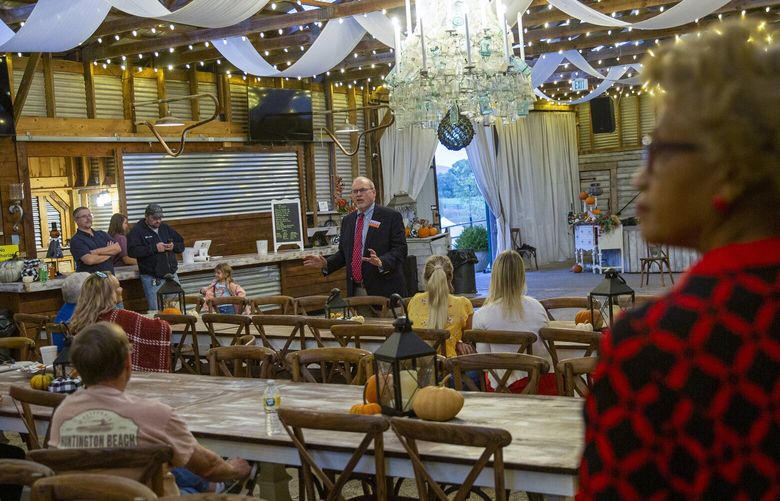 Jo Anne Price, right, who hosts weekly screenings of a film claiming the 2020 election was stolen, listens to Rep. H. Morgan Griffith (R-Va.), in Riner, Va., Oct. 6, 2022. The white majority is fading, the economy is changing, and there’s a pervasive sense of loss in districts where Republicans fought the outcome of the 2020 election. (Laura Saunders/The New York Times)