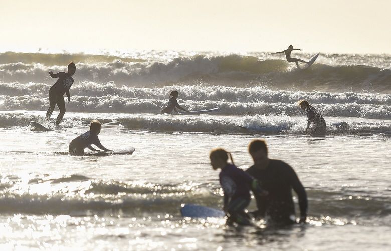 A view of the surfing scene on Croyde Beach in North Devon, England, Oct. 10, 2022. On the North Devon coast, where breathtaking cliffs give way to barreling waves, the surfing scene can hold its own among the best in Europe, and more girls and women are taking it on. (Mary Turner/The New York Times) XNYT58 XNYT58