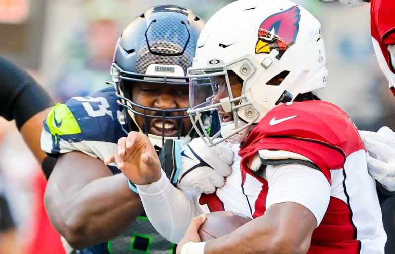 Seattle Seahawks defensive end Shelby Harris sacks Arizona Cardinals quarterback Kyler Murray during the fourth quarter. The Seahawks had six sacks on the day.  221865