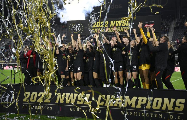 Portland Thorns FC celebrate with the trophy after they won the NWSL championship soccer match against the Kansas City Current, Saturday, Oct. 29, 2022, in Washington. Portland won 2-0. (AP Photo/Nick Wass) DCNW115 DCNW115