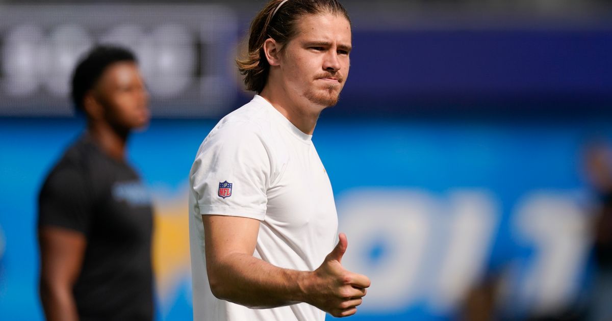 Los Angeles Chargers quarterback Justin Herbert (10) adjusts his helmet as  he warms up before an NFL football game against the Seattle Seahawks  Sunday, Oct. 23, 2022, in Inglewood, Calif. (AP Photo/Marcio