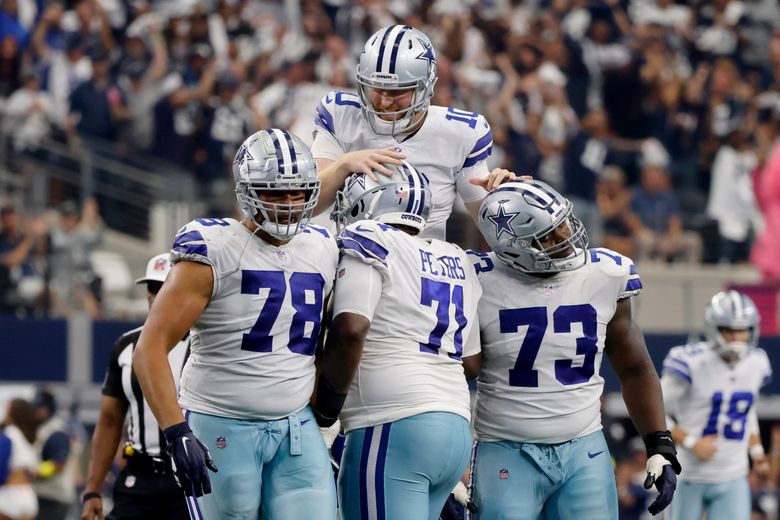 Dallas Cowboys quarterback Cooper Rush (10) hands the ball off