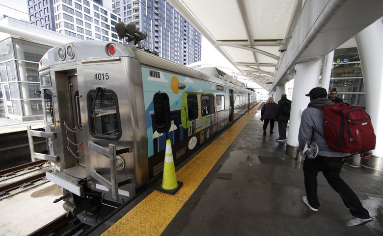 A passenger runs to catch the train to Denver International Airport at Union Station. (David Zalubowski / AP)