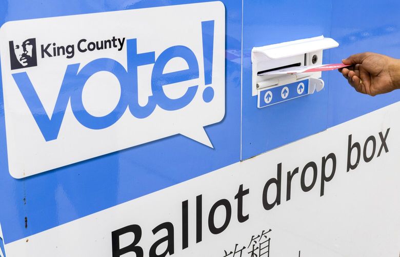 A voter drops his ballot into the ballot drop box at the NewHolly Neighborhood Campus in Seattle Tuesday, August 2, 2022.  Tuesday is Primary Election Day in Washington state.   221161 221161