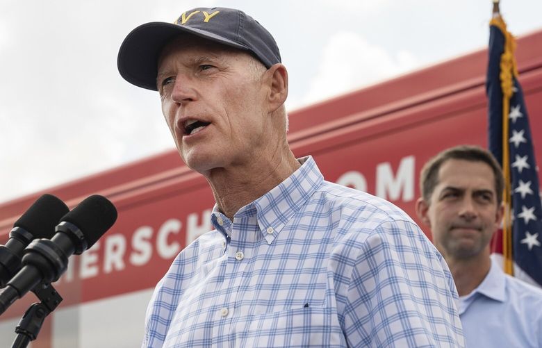 FILE – Sen. Rick Scott (R-Fla.) and Sen. Tom Cotton (R-Ark.), right, campaign for Herschel Walker in Carrollton, Ga. on Oct. 11, 2022. Scott has proposed subjecting nearly all federal spending programs to a renewal vote every year, which would make Medicare and Social Security more vulnerable to budget cuts. (Nicole Craine/The New York Times) XNYT14 XNYT14