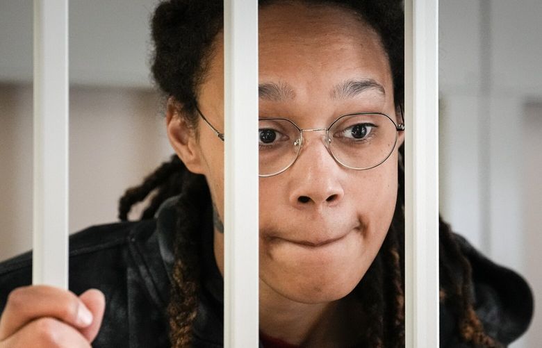 FILE – WNBA star and two-time Olympic gold medalist Brittney Griner speaks to her lawyers standing in a cage at a court room prior to a hearing, in Khimki just outside Moscow, Russia, Tuesday, July 26, 2022. A Russian court has on Tuesday, Oct. 23 started hearing American basketball star Brittney Griner’s appeal against her nine-year prison sentence for drug possession. (AP Photo/Alexander Zemlianichenko, Pool, File) XAZ115 XAZ115