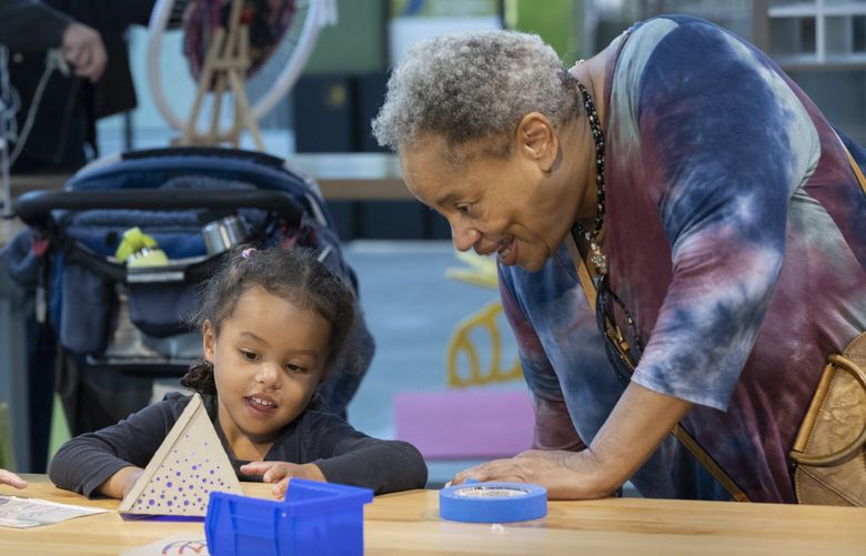Jacqui Jackson (r) helps her four-year-old granddaughter Callista Mullins build a LED lantern  in Pacific Science Centerâ€™s Tinker Tank exhibit at the center Wednesday, October 19, 2022.  Visitors can work on engineering and design challenges through hands-on activities in the Tinker Tank exhibit. The center is celebrating its 60th anniversary. 221904