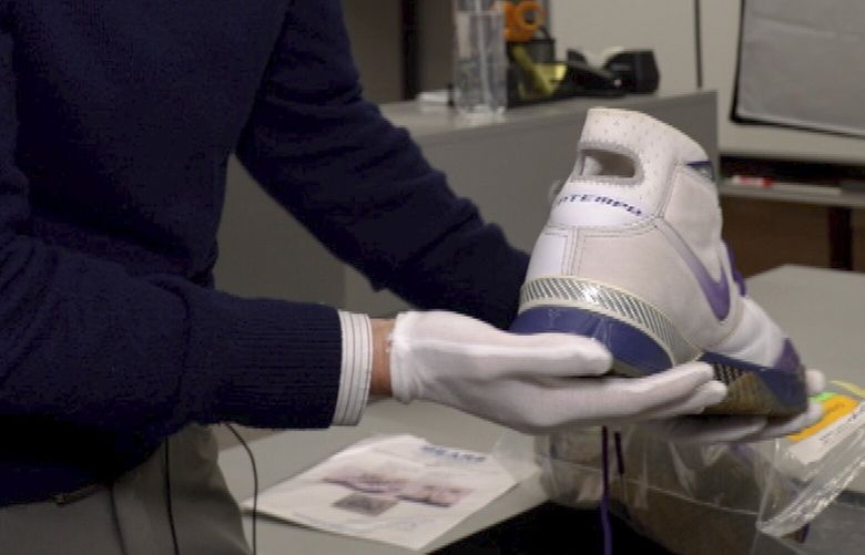 Ross Hoffman, CEO of Collectors Vault, shows a shoe worn and signed by NBA legend Kobe Bryant on Oct. 21, 2022, in Delaware. The footwear is among hundreds of items stored at Collectors Vault, a new venture that makes it easier for collectors to store and trade memorabilia. (AP Photo/Davidde Corran)