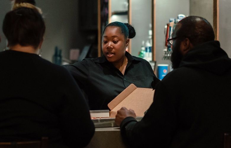 Olivia Kelly, at one of her jobs, as a bartender at a movie theater in Mequon, a suburb of Milwaukee, and who said she plans to vote for Lt. Gov. Mandela Barnes, the Democratic candidate for U.S. Senate, Oct. 27, 2022. A caricature of the suburban female voter as a “soccer mom” looms large in U.S. politics, but in battleground regions, many voters don’t fit the stereotype and, perhaps, never did. (Jamie Kelter Davis/The New York Times)