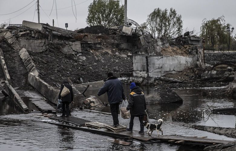 Civilians cross the remains of a bridge that was destroyed by Russian bombardment in Bakhmut, a heavily-contested city in Ukraineâ€™s Donetsk region, on Saturday, Nov. 5, 2022. The tremendous strain on Ukraineâ€™s power grid is the result of Russia targeting power plants, lines and substations across the country. (Finbarr Oâ€™Reilly/The New York Times) XNYT81 XNYT81