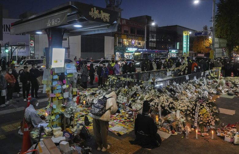 Mourners pay respects to victims of the fatal stampede, at a memorial by a subway station exit in the Itaewon neighborhood of Seoul, South Korea, on Friday, Nov. 4, 2022. Young South Koreans used to come to this district for its diversity and vibrant nightlife. “Itaewon freedom,” they called it. Now, the neighborhood has become a sobering monument of grief and soul-searching. (Chang W. Lee/The New York Times)

 XNYT51 XNYT51