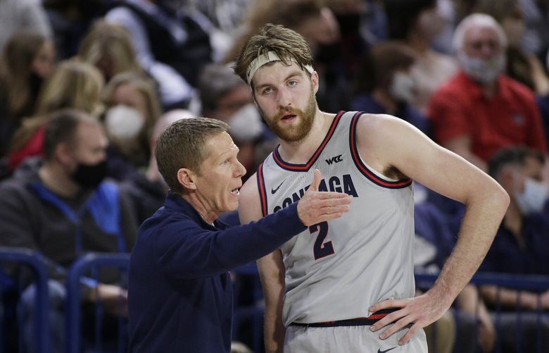 FILE – Gonzaga head coach Mark Few, left, speaks with forward Drew Timme (2) during the first half of an NCAA college basketball game against Loyola Marymount, Thursday, Jan. 27, 2022, in Spokane, Wash. Few believes Timmeâ€™s persona sometimes overshadows what he has accomplished on the floor. (AP Photo/Young Kwak, File)
